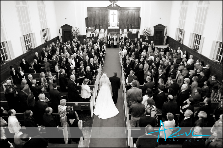 The photographer documents Jennah walking down the aisle as everyone stands for the bride while in the First Presbyterian Church in Wilson. 