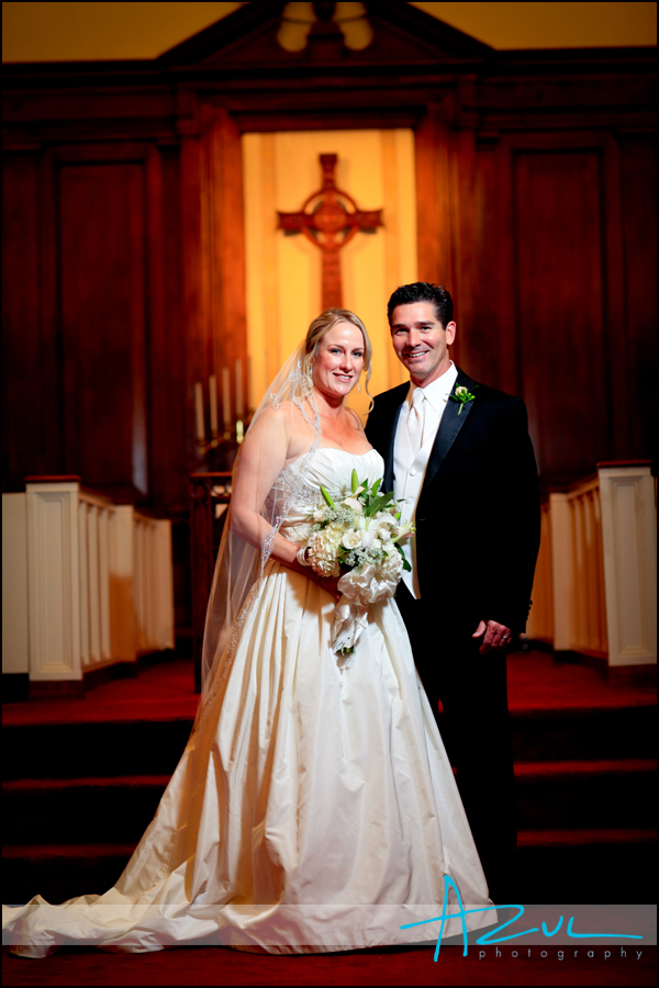 Jenna smiles for the photographer with her husband while at her Wilson wedding