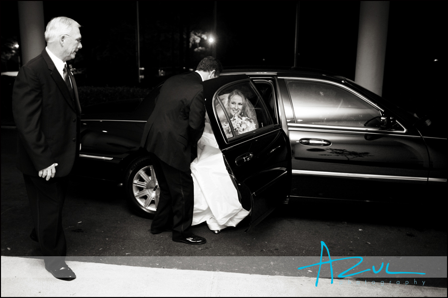 The groom assists his bride as they arrive to the Wilson Country Club for the reception.